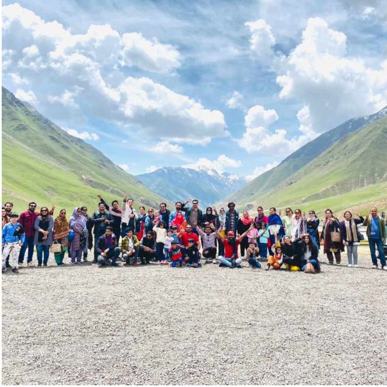 Large tour group in a wide mountain valley in Gilgit Baltistan