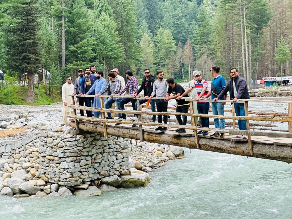 Group on a wooden bridge in Kumrat Valley